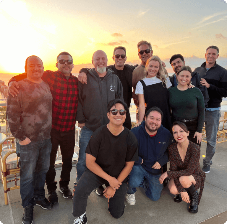 Group of Havas Edge employees standing in front of a sunset