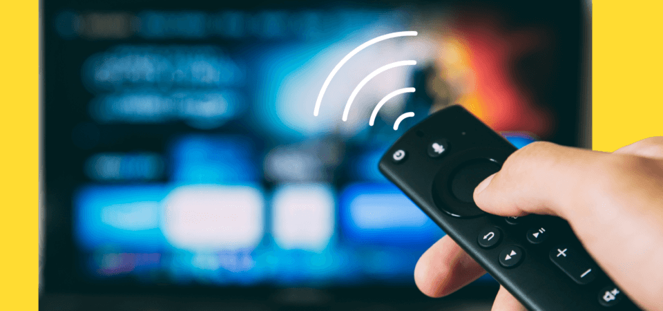 A hand pointing a remote at a screen