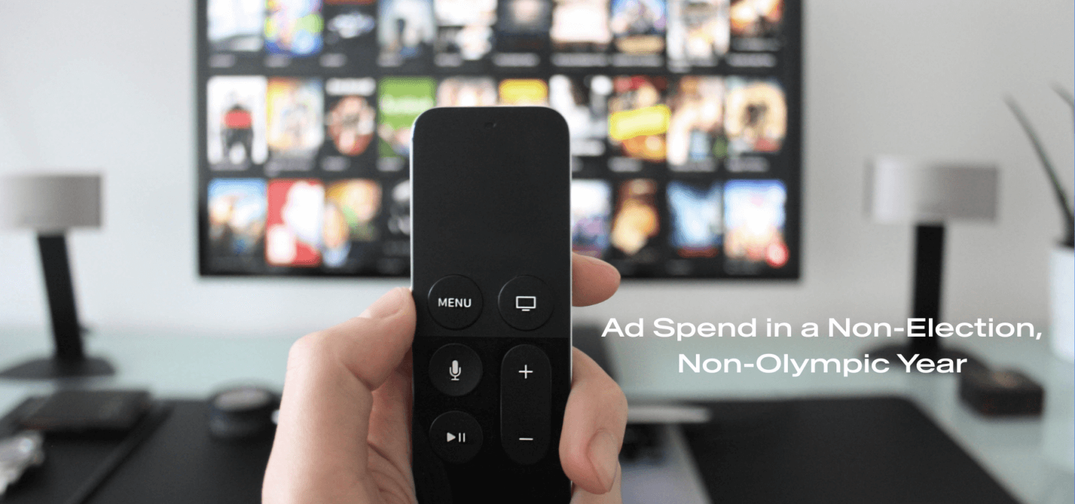 Image of remote control with a TV in the background showing different movies; Ad spend