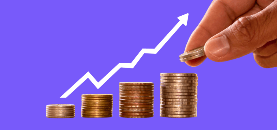 Stacks of coins trending upward with an arrow