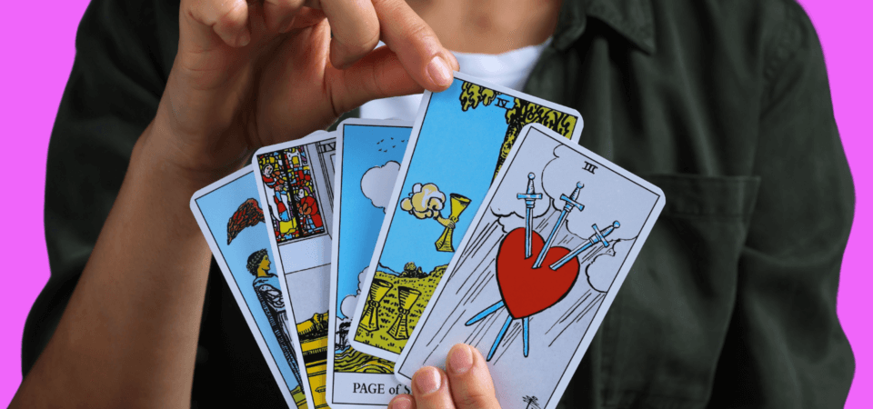 A person holding a deck of tarot cards