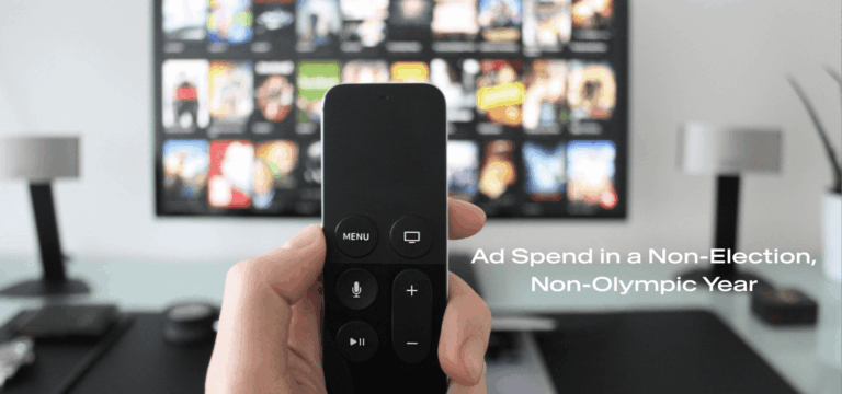 Image of remote control with a TV in the background showing different movies; Ad spend